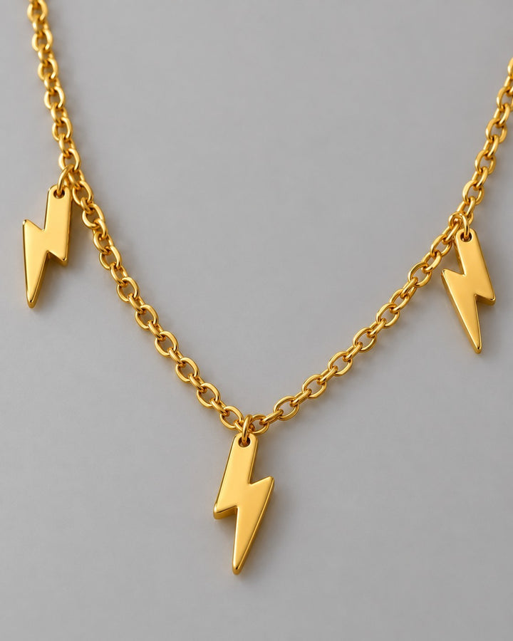 Elli Jewellery gold plated waterproof necklace featuring three hanging lightning bolt charms on a delicate chain