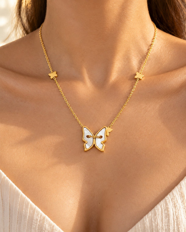 Elli Jewellery gold plated necklace featuring a mother of pearl butterfly pendant and small butterfly chain accents.