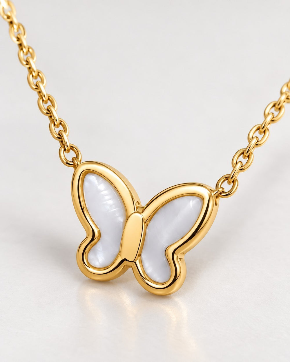 Elli Jewellery gold plated butterfly pendant necklace featuring iridescent mother of pearl inlay on a delicate chain