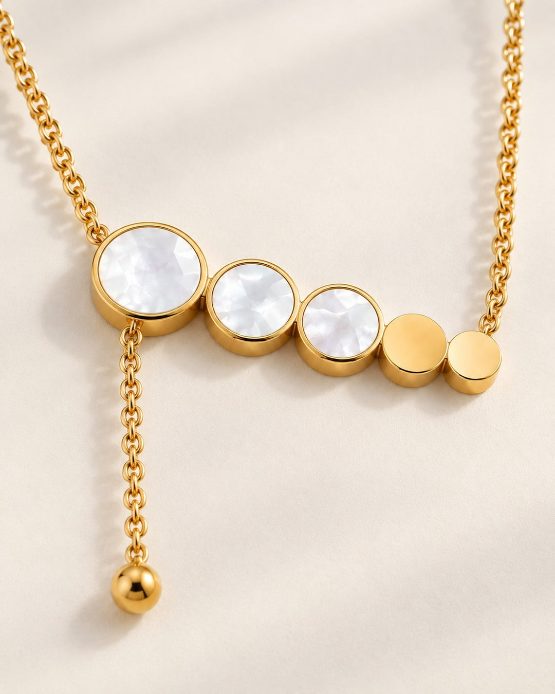 Elli Jewellery gold plated necklace featuring a row of circular mother of pearl charms and a delicate drop chain