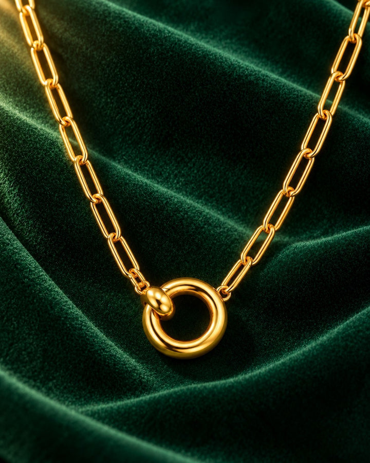 Elli Jewellery gold plated waterproof paperlink chain necklace with a minimalist round pendant on green velvet