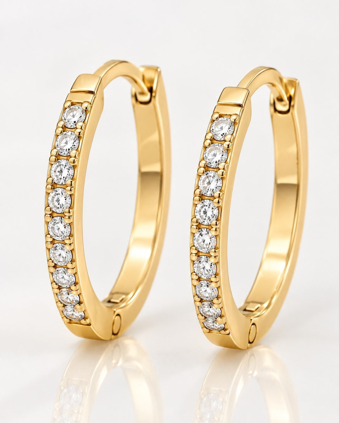 Elli Jewellery gold plated hoop earrings featuring a row of sparkling pavé-set clear crystals and hinged closures.