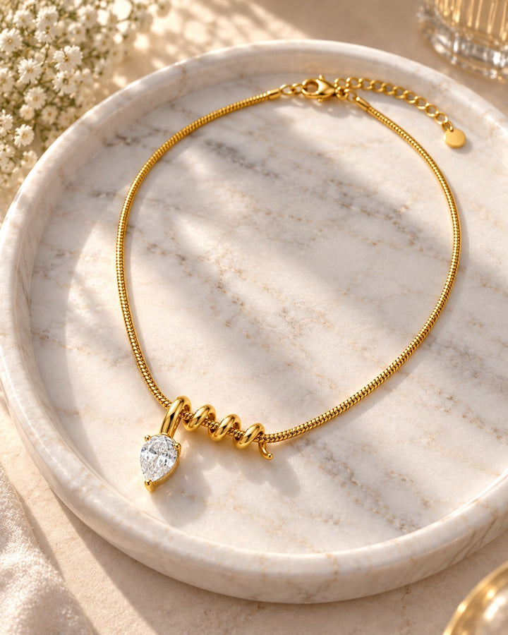 Elli Jewellery gold plated waterproof necklace featuring a pear shaped diamante crystal pendant on a snake chain.