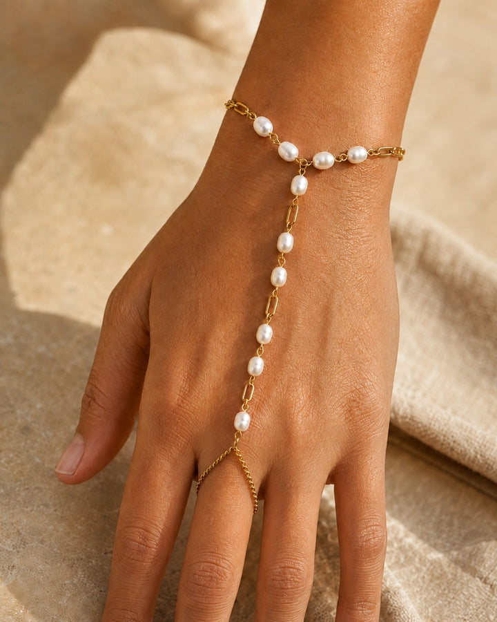 Elli Jewellery gold plated hand chain bracelet with delicate pearl embellishments and an adjustable ring