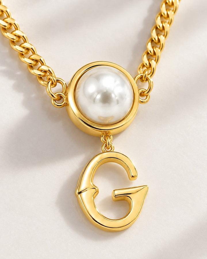 Elli Jewellery gold plated curb chain necklace featuring a white pearl pendant and a dangling letter G charm.