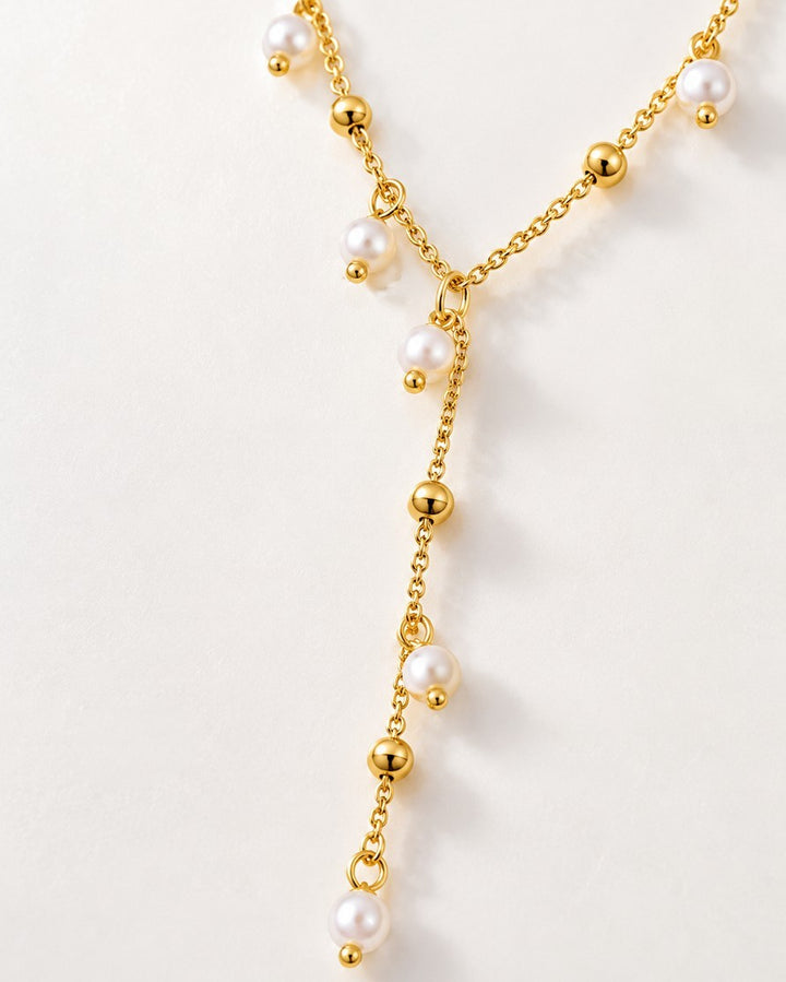 Elli Jewellery gold plated waterproof lariat necklace featuring delicate chain with lustrous pearl and bead drops.