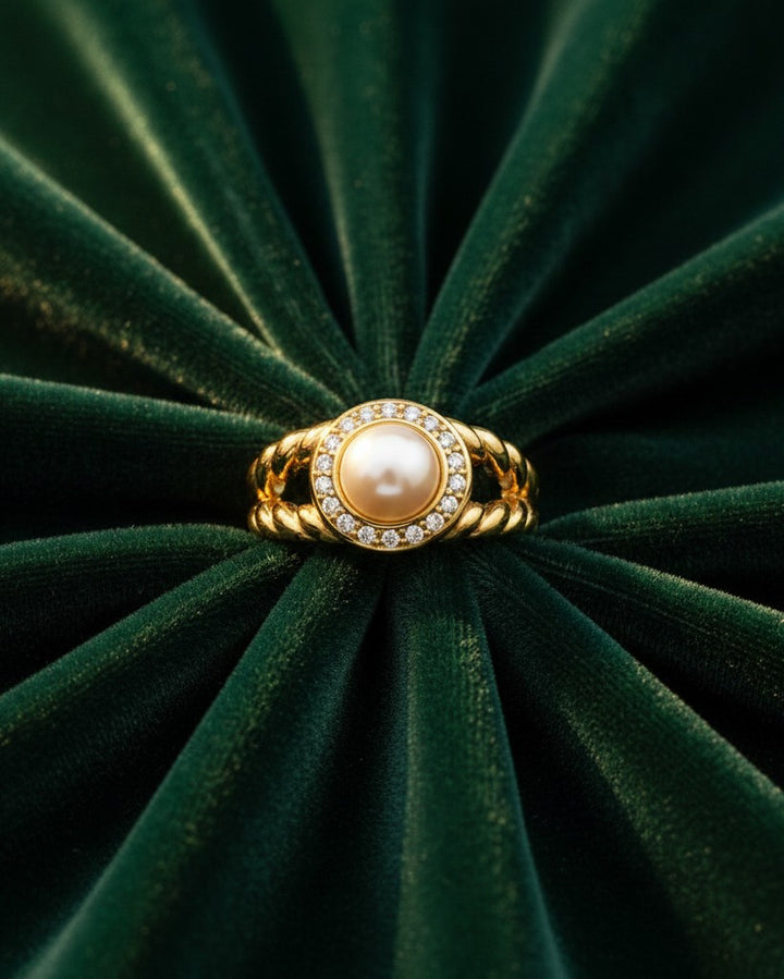 Elli Jewellery gold plated statement ring featuring a central pearl surrounded by sparkling zirconia pavé on a twisted band