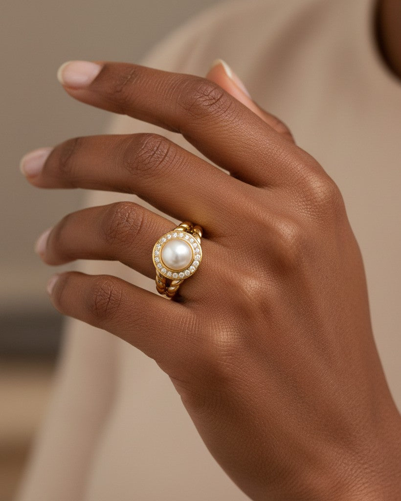 Elli Jewellery gold plated statement ring featuring a central pearl surrounded by sparkling zirconia pavé on a model