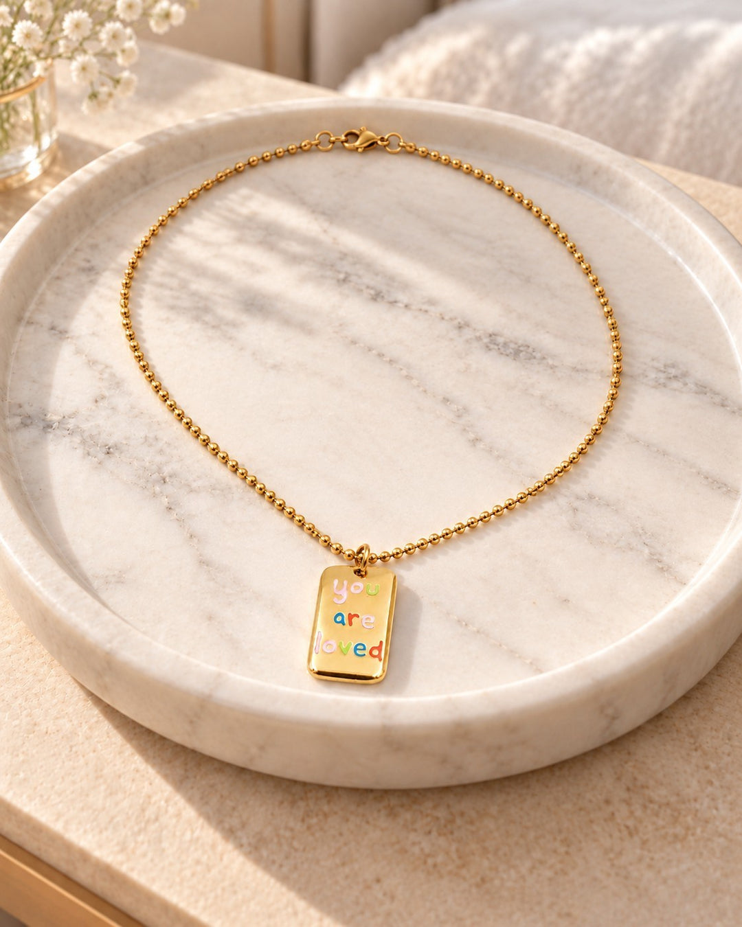 Elli Jewellery gold plated rectangular pendant necklace featuring the engraved text you are loved in colorful letters