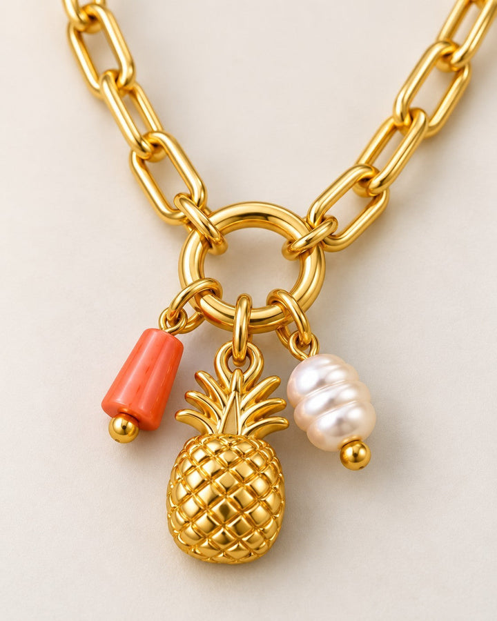 Elli Jewellery gold plated pineapple pendant necklace featuring a coral charm and a white pearl on a chunky chain