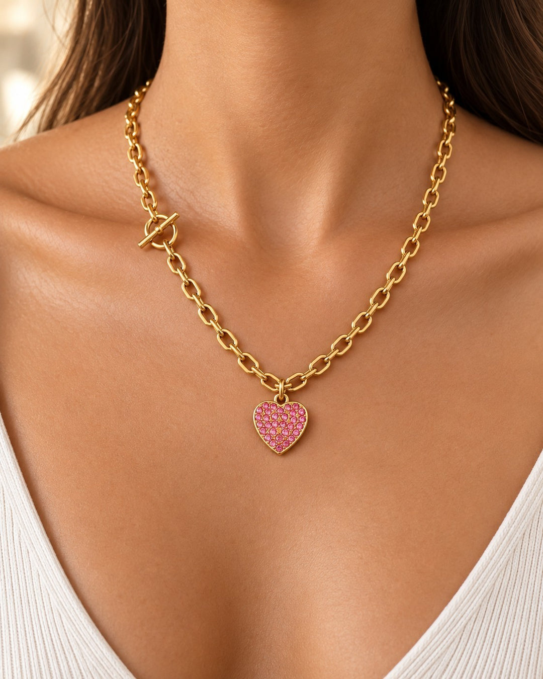 Elli Jewellery gold plated chain necklace featuring a pink diamante heart pendant and a modern T-bar clasp detail.