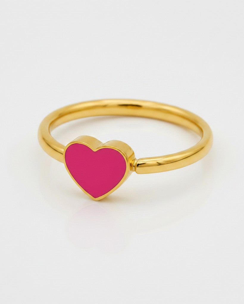 Elli Jewellery gold plated ring featuring a vibrant pink enamel heart design on a polished gold band.