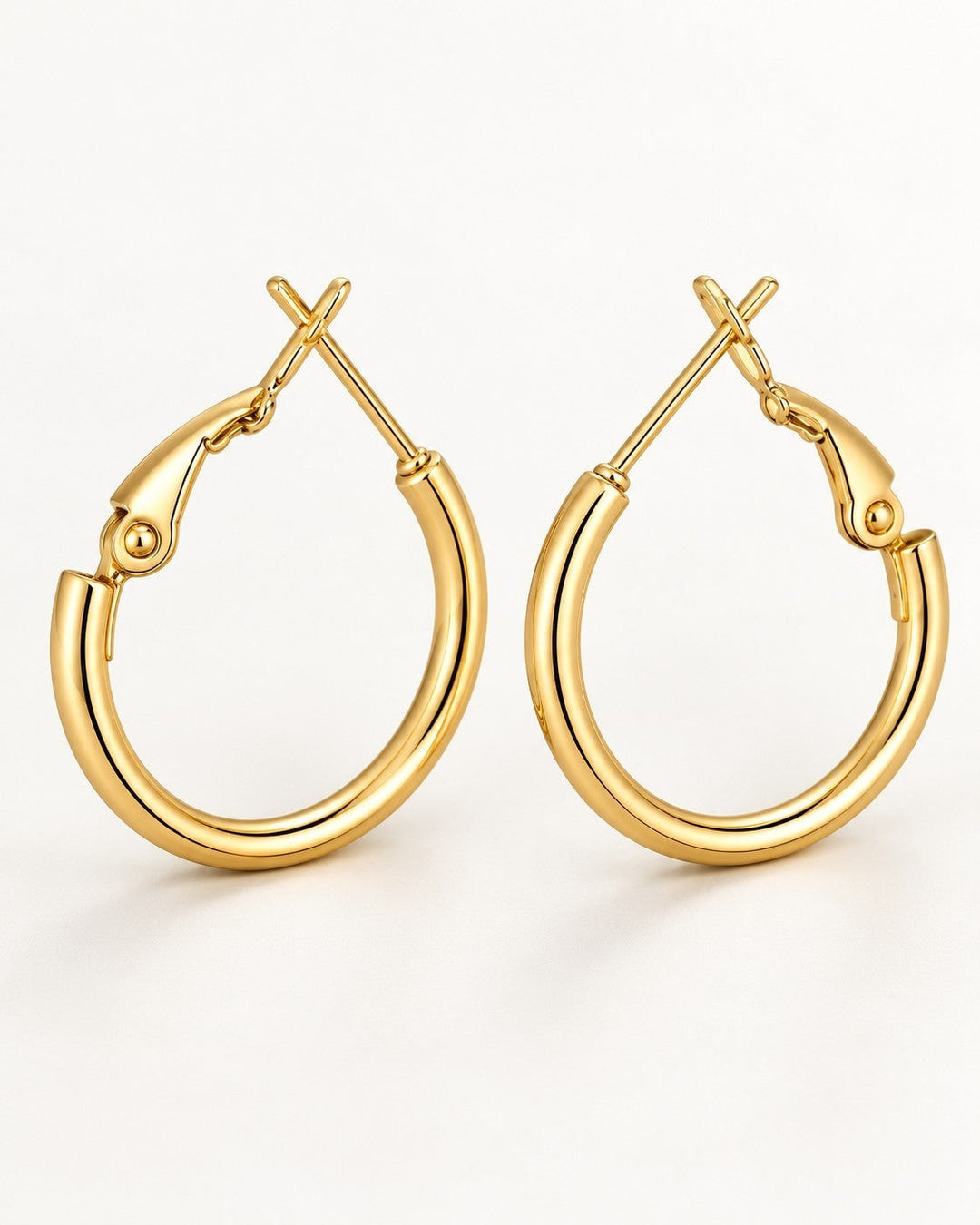 Elli Jewellery polished 18ct gold plated hoop earrings with a secure hinged clasp on a clean white background