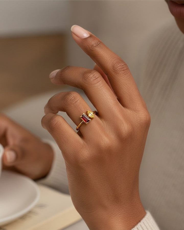 Elli Jewellery gold-toned stacking ring featuring a rectangular red and a marquise yellow zirconia stone on a finger