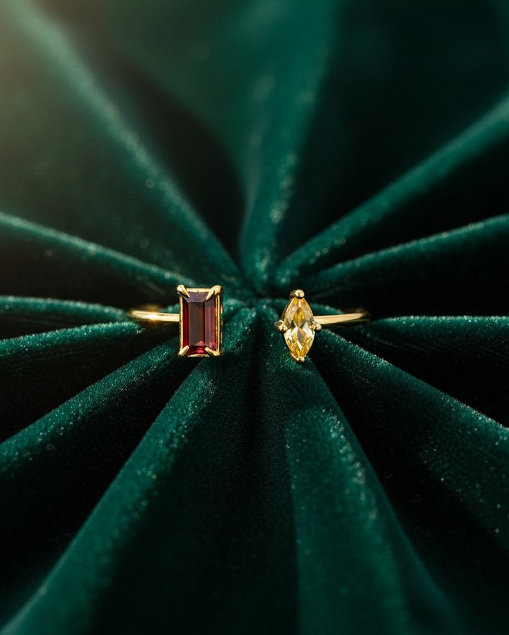 Elli Jewellery gold-plated stacking rings with a rectangular red and marquise yellow zirconia stone on green velvet