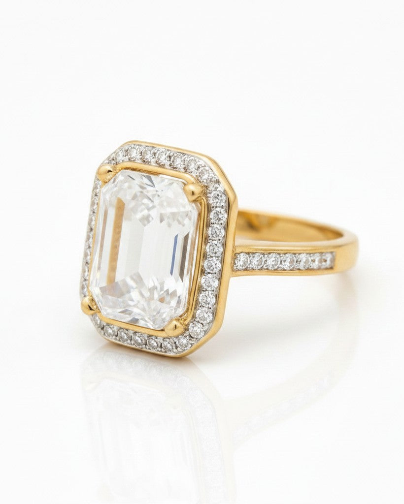 Elli Jewellery gold plated chunky ring with a large rectangular clear crystal and pavé stone halo setting.