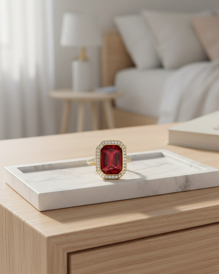 Elli Jewellery gold plated chunky ring featuring a large rectangular red crystal surrounded by small white stones.