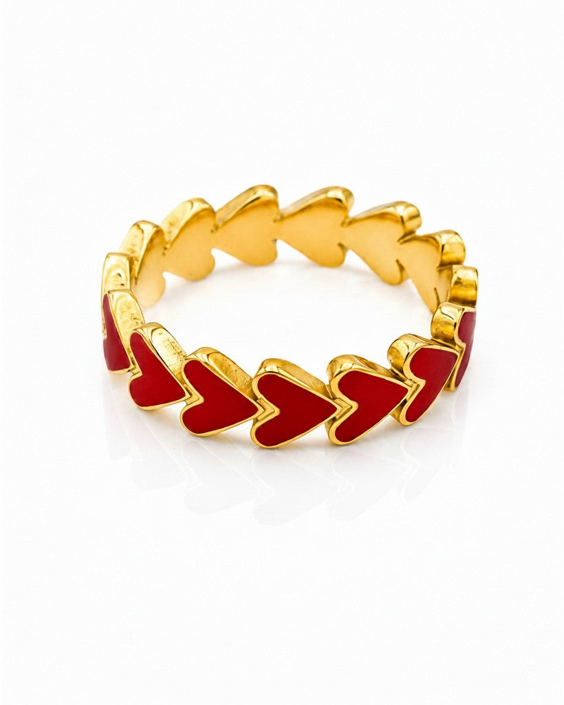 Elli Jewellery gold plated ring featuring a continuous band of vibrant red enamel hearts in a cluster design.