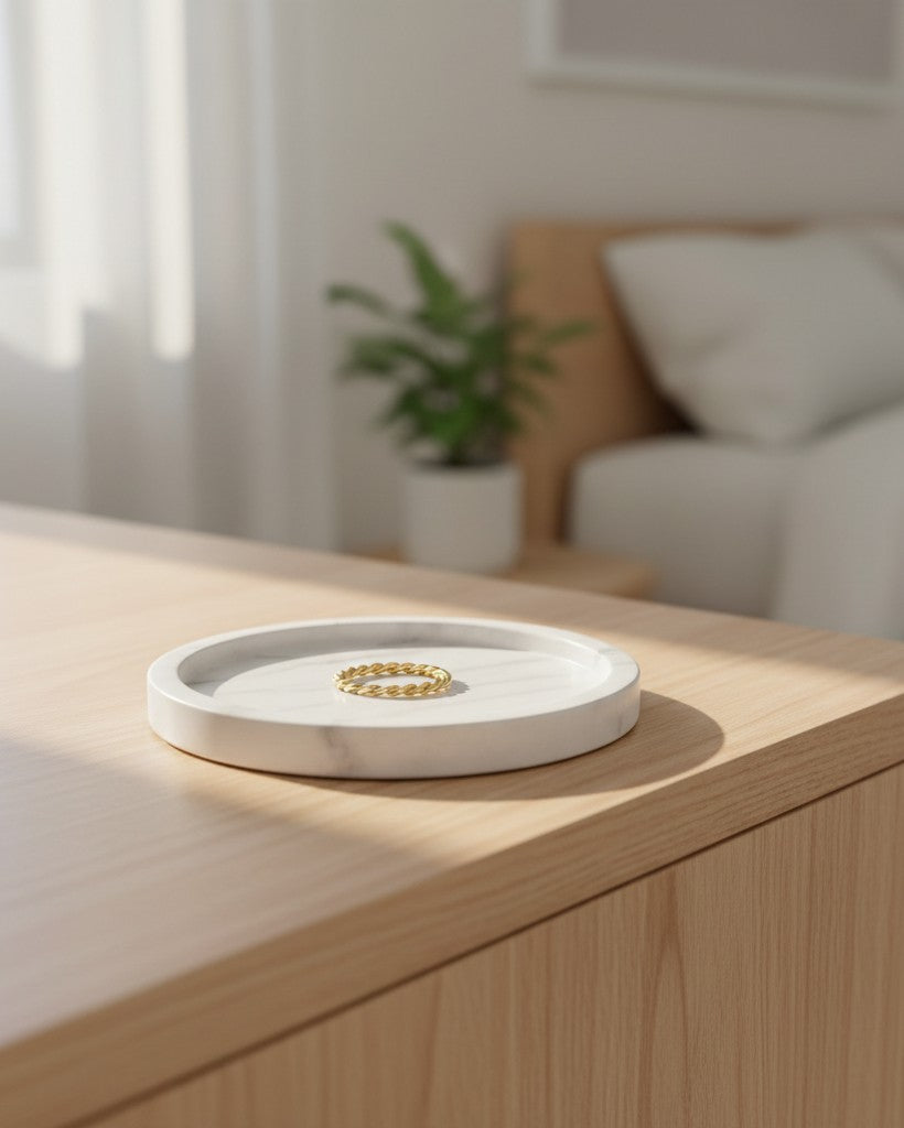 Elli Jewellery gold plated geometric rhombus statement ring resting on a white marble tray in a bright bedroom.