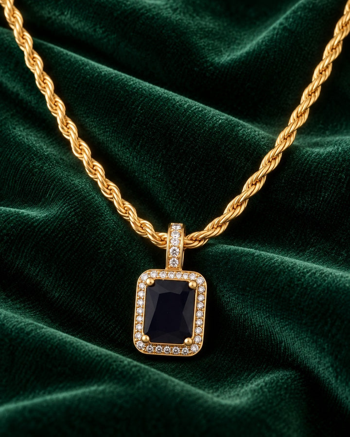 Elli Jewellery gold plated rope chain necklace with a rectangular black cubic zirconia pendant on green velvet