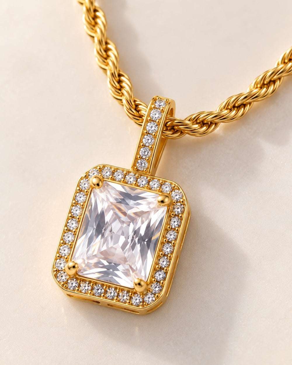 Elli Jewellery gold plated rope chain necklace with a rectangular clear cubic zirconia pendant and halo setting.
