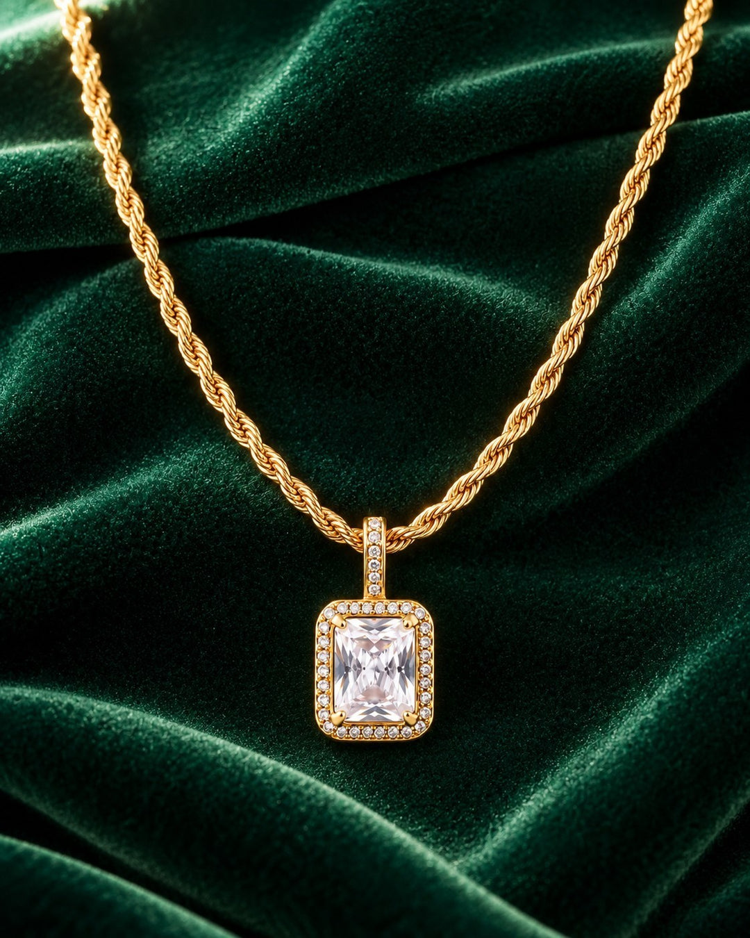 Elli Jewellery gold plated rope chain necklace with a rectangular clear cubic zirconia pendant on green velvet