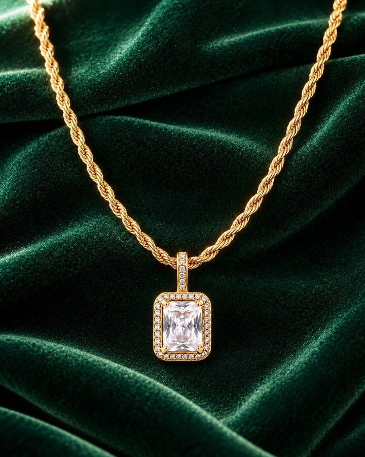 Elli Jewellery gold plated rope chain necklace with a rectangular clear cubic zirconia pendant on green velvet