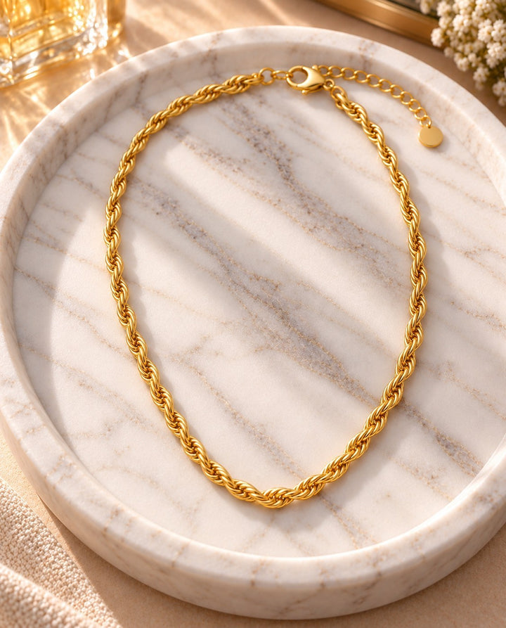 Elli Jewellery gold plated chunky rope chain necklace resting on a white marble tray with soft sunlight