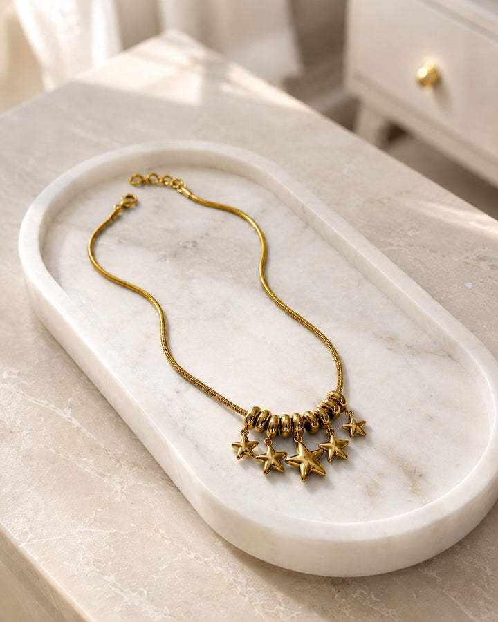 Elli Jewellery gold plated necklace featuring a delicate chain with a cluster of star charms and rondelle beads