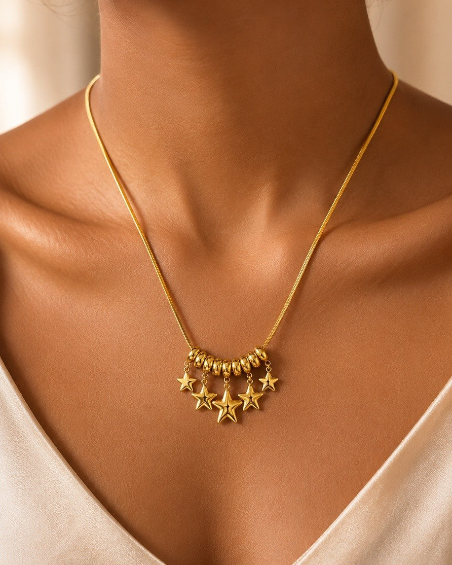 Elli Jewellery gold plated necklace featuring a delicate chain with a cluster of star charms and rondelle beads