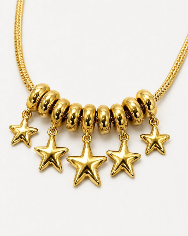 Elli Jewellery gold plated necklace featuring a cluster of rondelle beads and five polished star charms on a chain.