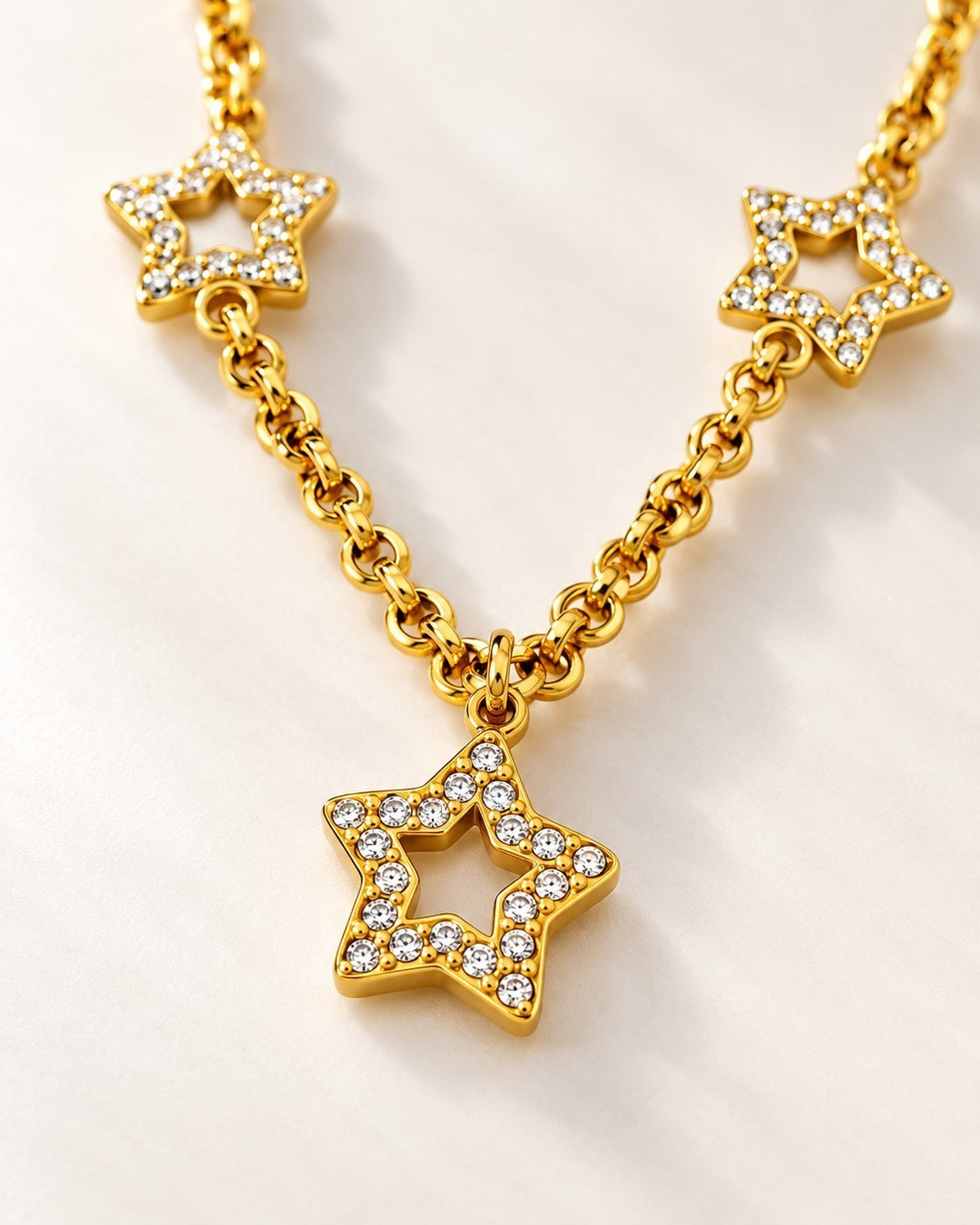 Elli Jewellery gold plated celestial star necklace featuring multiple star charms encrusted with sparkling crystals