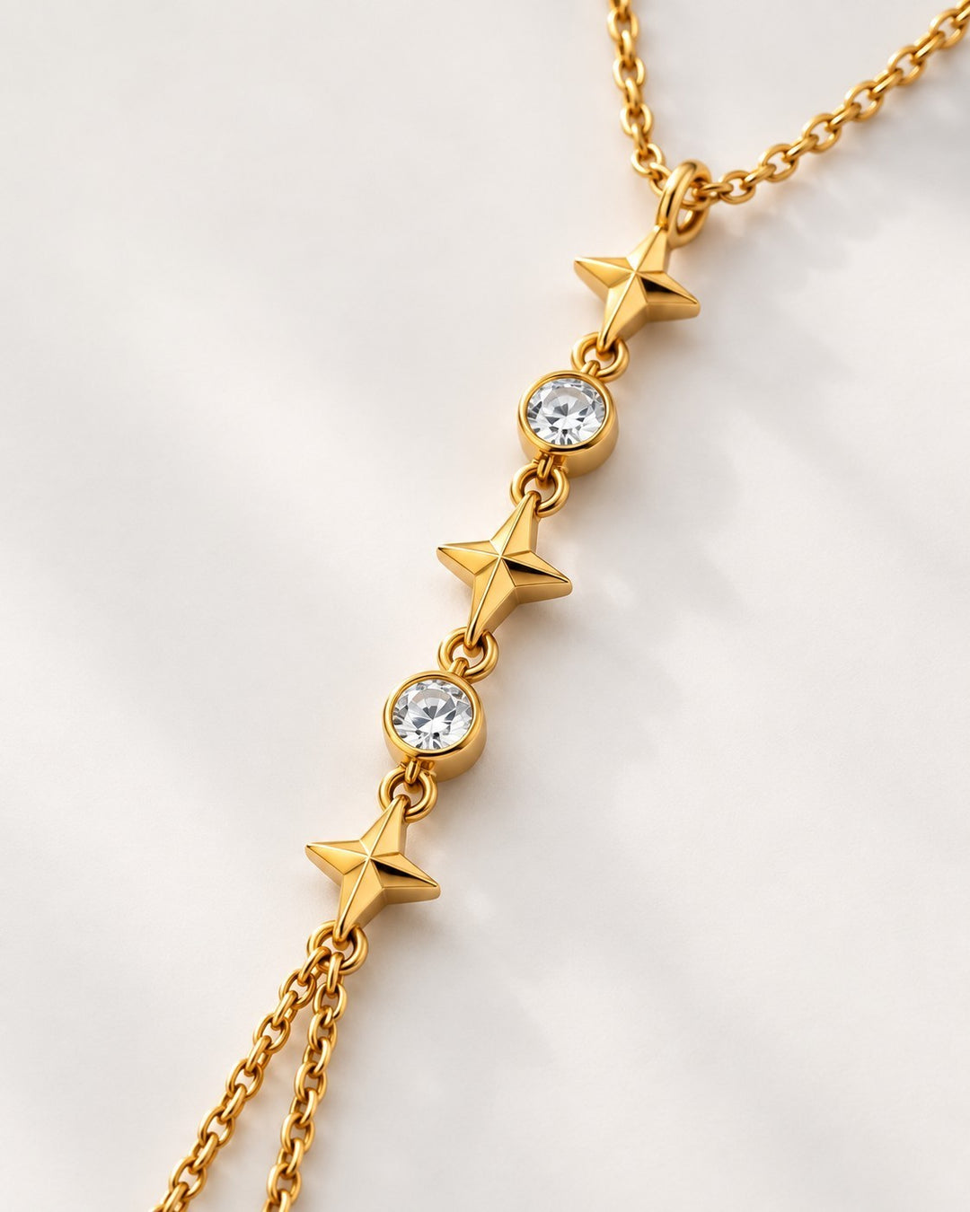 Elli Jewellery gold plated multi-layered chain necklace featuring alternating star charms and clear crystal stones.