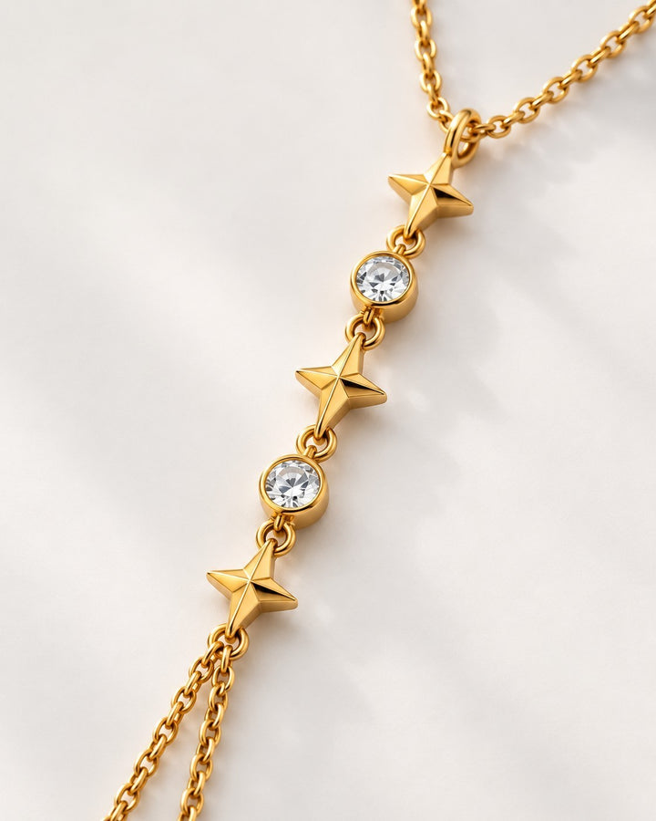 Elli Jewellery gold plated multi-layered chain necklace featuring alternating star charms and clear crystal stones.