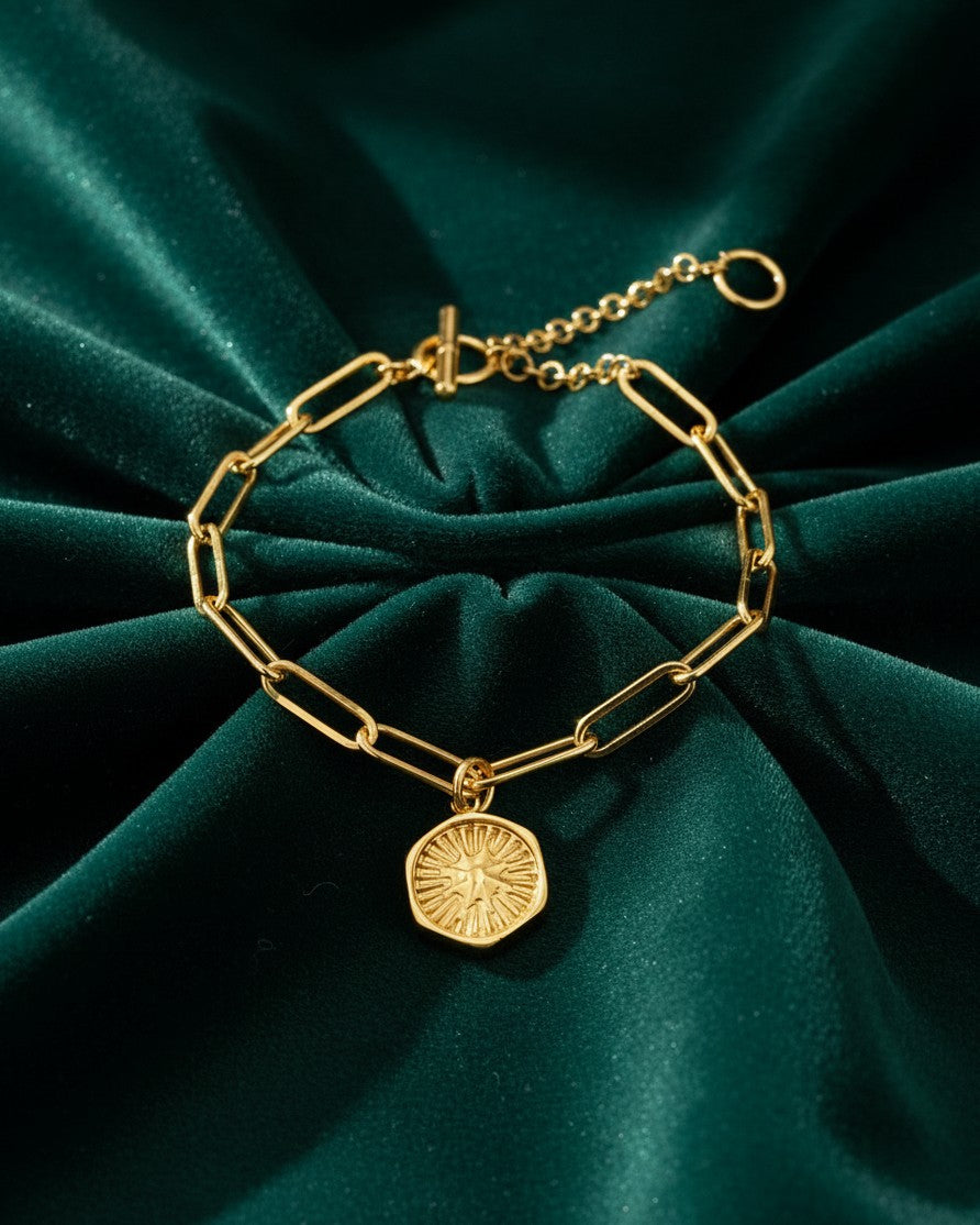 Elli Jewellery gold plated waterproof bracelet featuring a celestial starburst charm on a delicate link chain