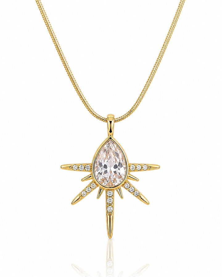 Elli Jewellery gold plated starburst pendant necklace featuring a central pear-shaped crystal and pavé stone accents.