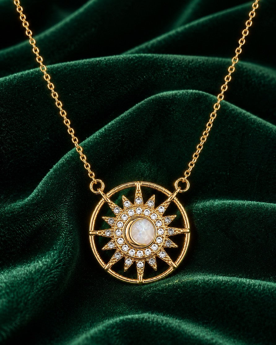 Elli Jewellery gold plated starburst medallion pendant necklace with a cream cabochon and clear crystal accents.