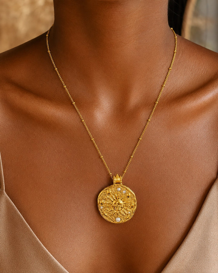 Elli Jewellery gold plated celestial sun medallion necklace with pearl accents on a delicate beaded station chain