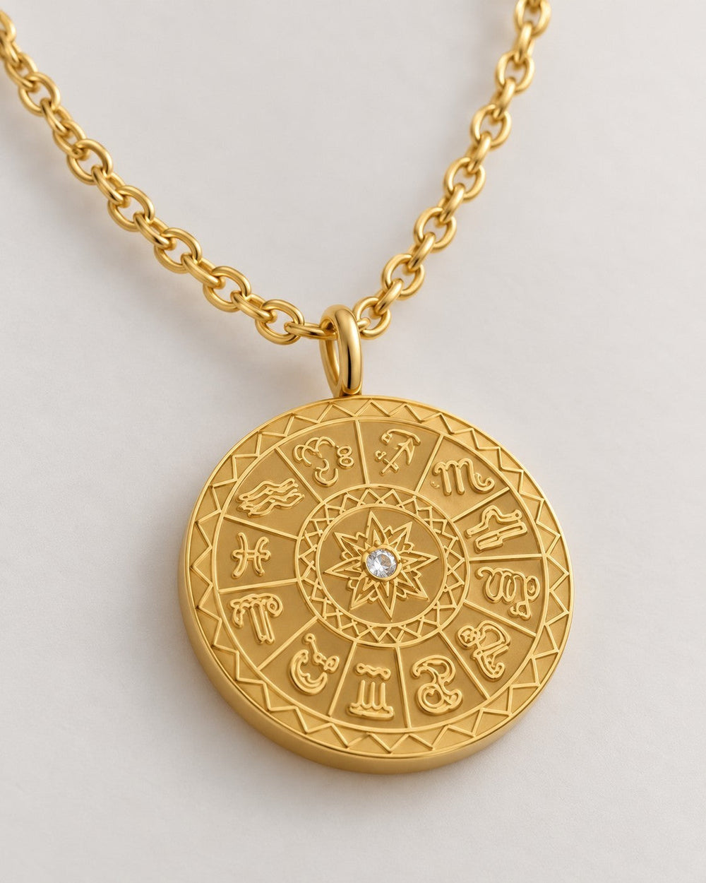 Elli Jewellery gold plated celestial sundial coin pendant necklace with a central crystal on a delicate chain