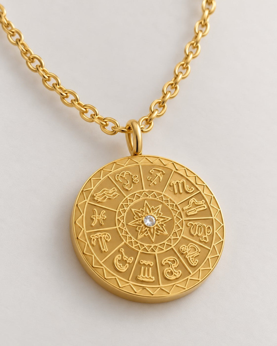 Elli Jewellery gold plated celestial sundial coin pendant necklace with a central crystal on a delicate chain