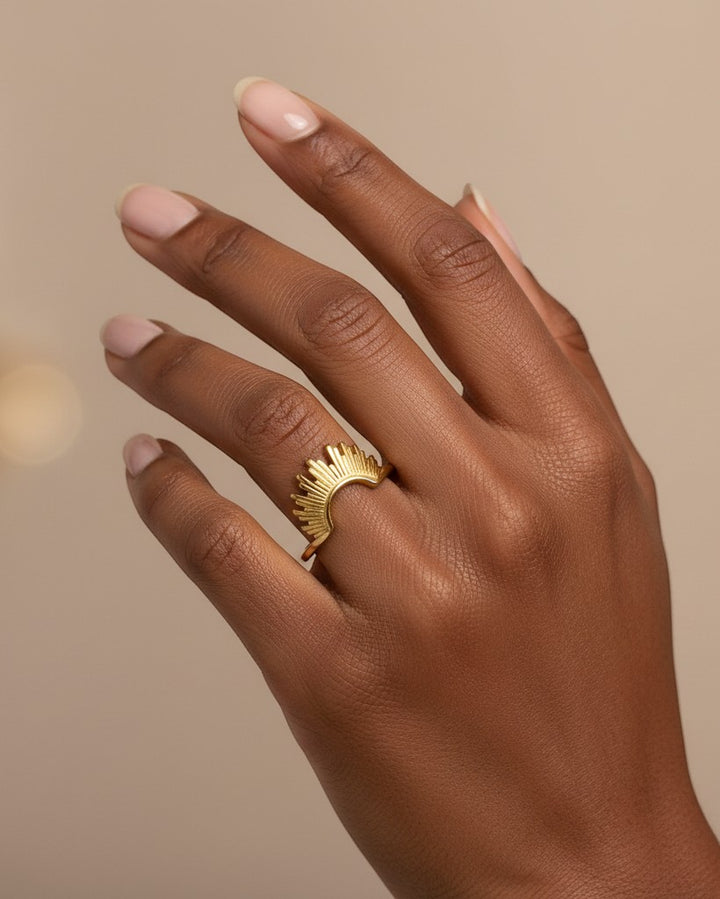 Elli Jewellery gold plated waterproof sunflower stacking ring worn on a finger with a sunburst petal design