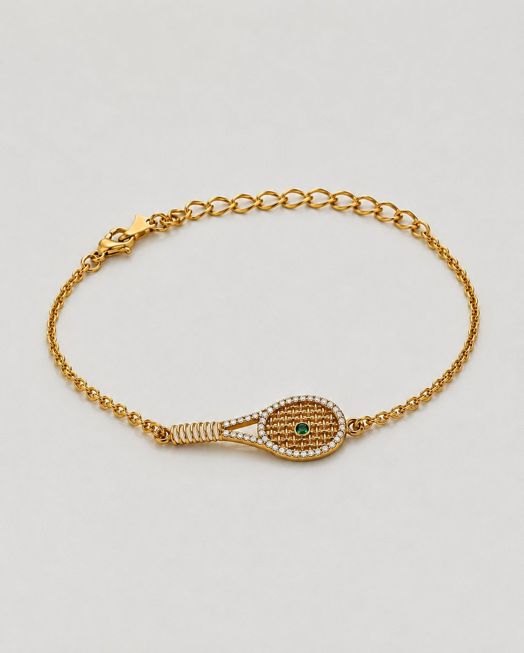 Elli Jewellery gold plated tennis racquet charm bracelet with pavé crystals and a green crystal ball on a chain