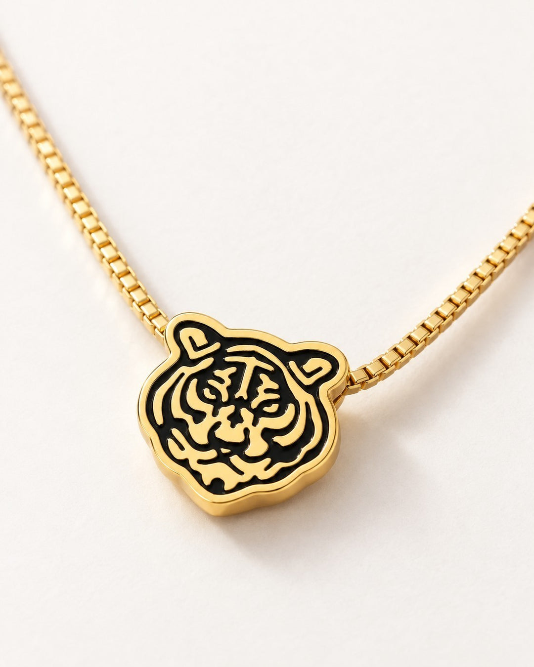 Elli Jewellery gold plated tiger head pendant with black enamel stripes on a delicate gold box chain