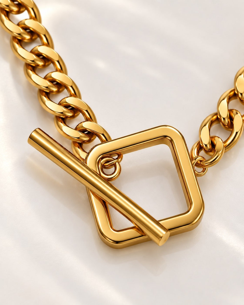 Elli Jewellery gold plated waterproof chain necklace featuring a square toggle clasp closure on a white background