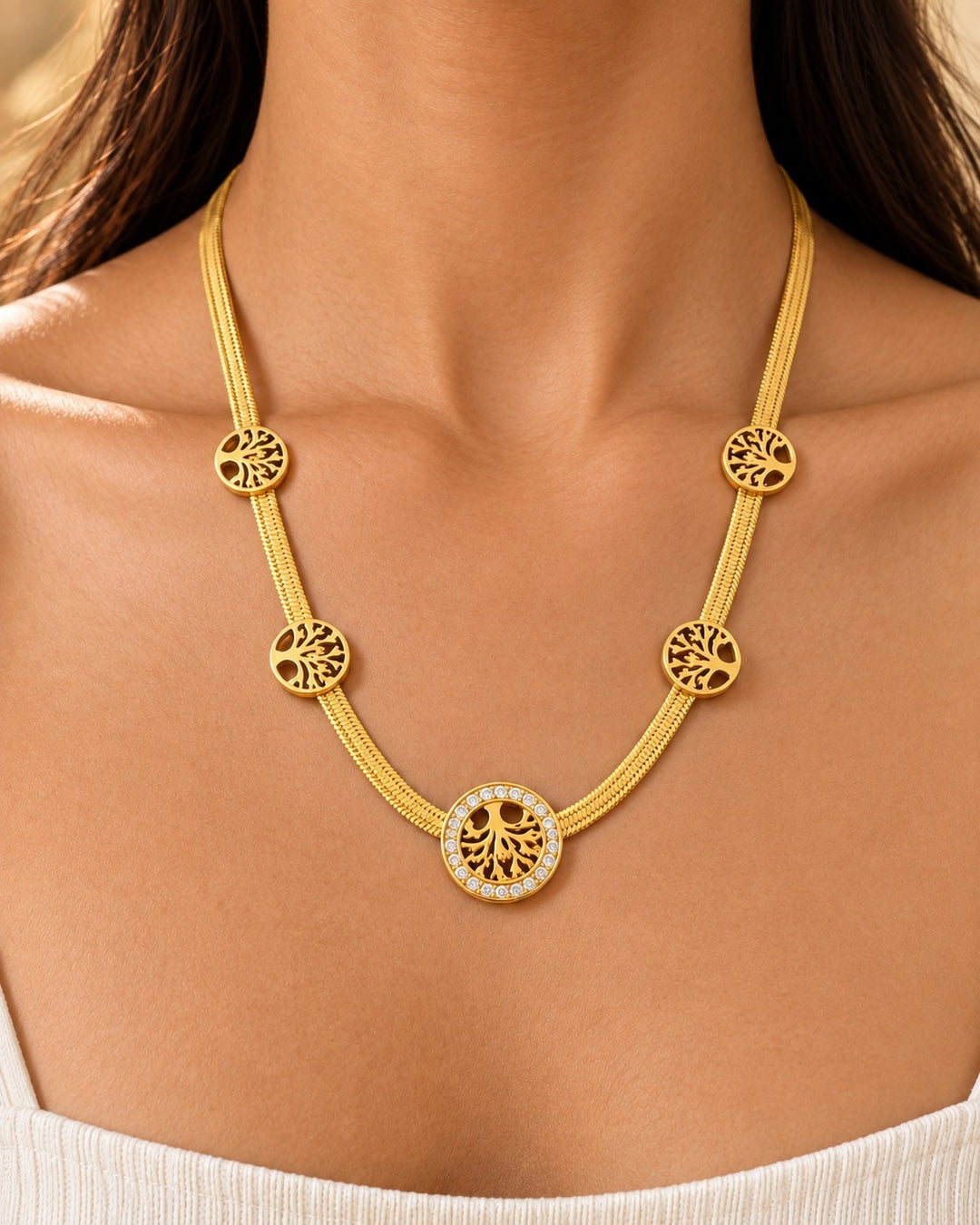 Elli Jewellery gold plated Tree of Life necklace with crystal accents worn on a model