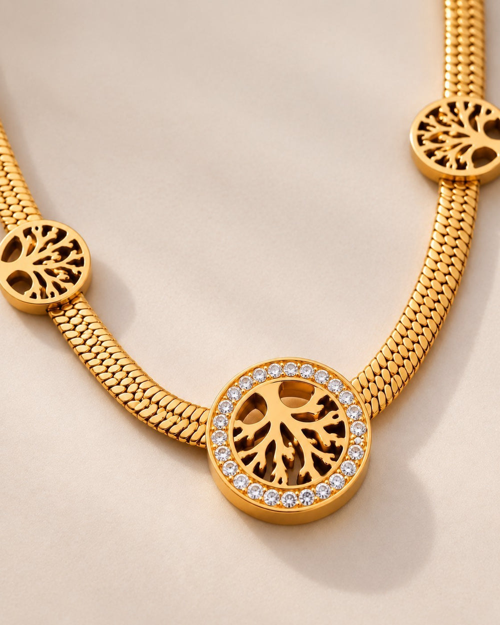 Elli Jewellery gold plated Tree of Life necklace featuring crystal-encrusted circular pendants on a snake chain.