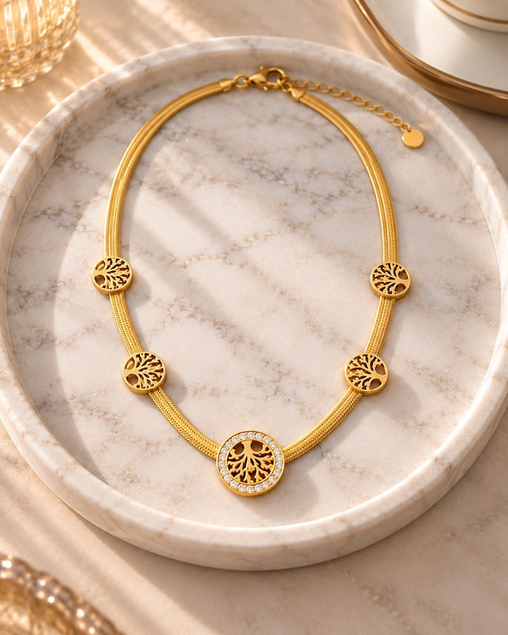Elli Jewellery gold plated Tree of Life necklace with crystal accents on a marble tray