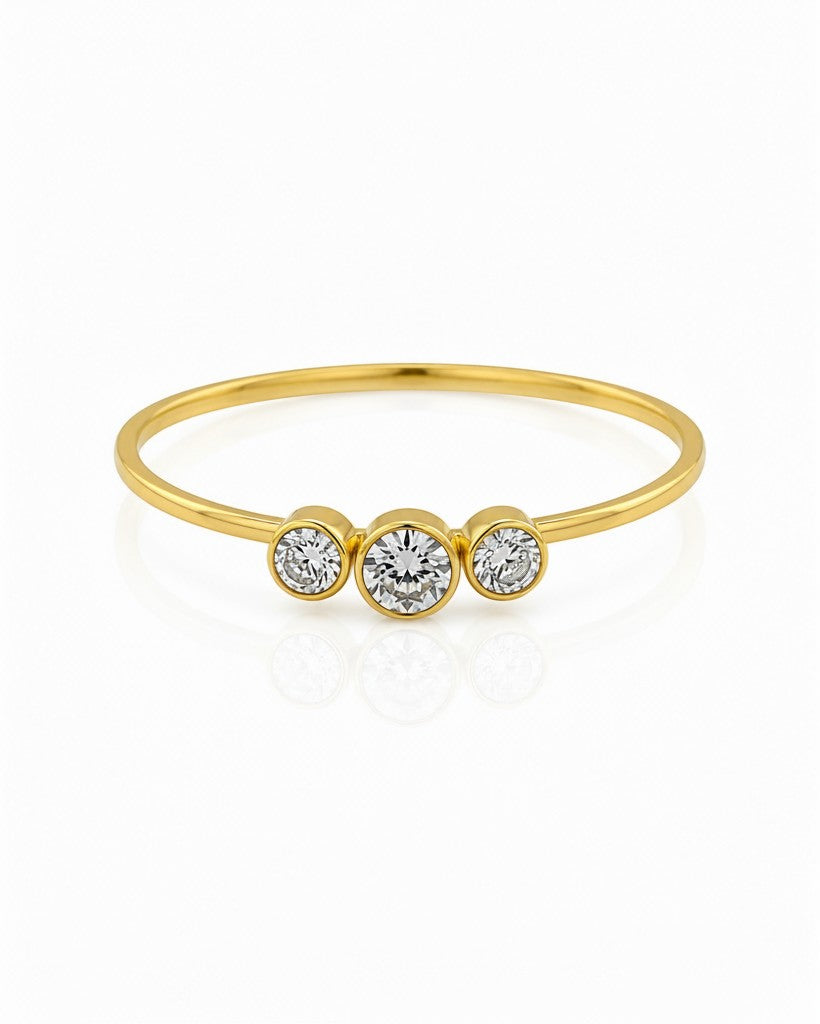 Elli Jewellery gold plated trilogy ring featuring three sparkling cubic zirconia stones in a delicate minimalist band.