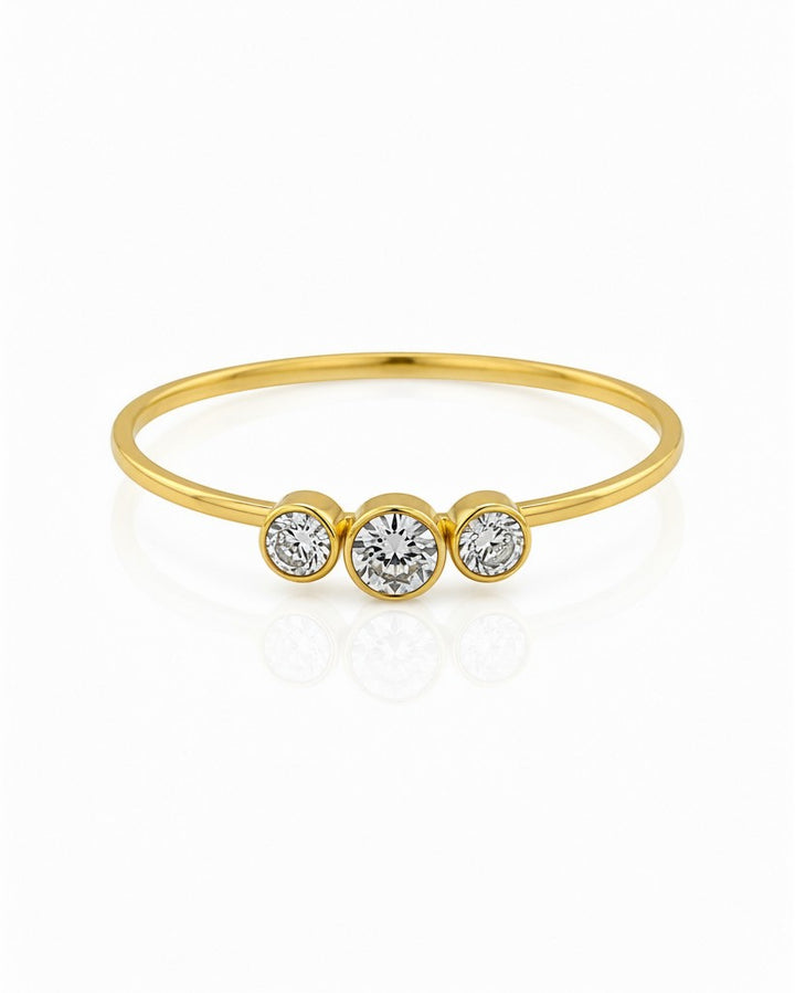 Elli Jewellery gold plated trilogy ring featuring three sparkling cubic zirconia stones in a delicate minimalist band.