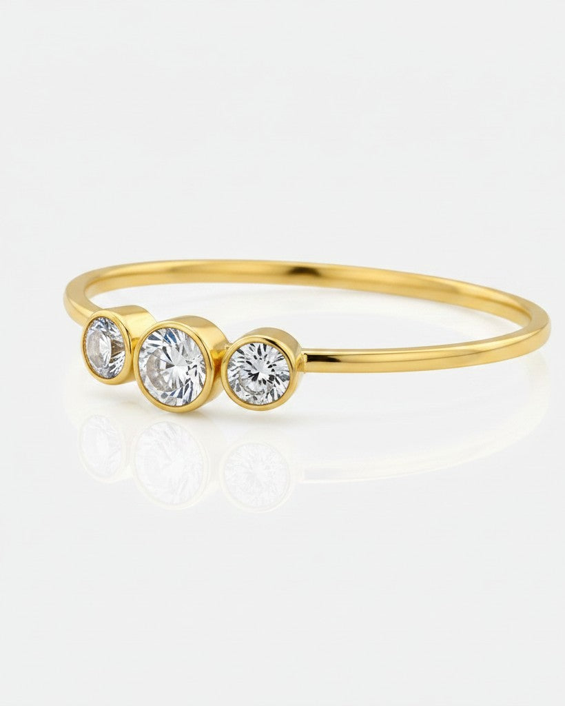 Elli Jewellery gold plated trilogy ring featuring three round cubic zirconia stones in a delicate bezel setting.